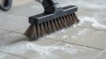 Detailed shot of a professional deep cleaning a bathroom tile with a scrub brush