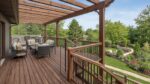 Elevated timber deck with pergola and outdoor furniture overlooking a garden, showing deck height advantage and railing detail