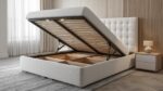Gas-lift storage queen bed frame with white upholstery and open base storage compartments
