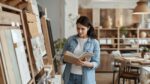 Homeowner choosing eco-friendly paint and sustainable materials at a design showroom