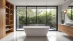 Luxurious freestanding tub installed in modern Australian bathroom with floor-mounted bath filler, timber accents and large window