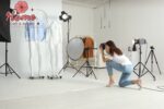 Person photographing rooms in a showroom that appeal to their personal design sensibility